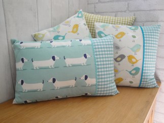 aqua dachshund with bird cushion on blanket box 2